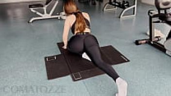 In the gym, a big girl wearing tight leggings was rewarded with a cream pie after her workout.