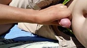 In front of the public beach, a girl masturbates her partner.