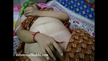 Velamma, a mature Indian housewife, is attempting to have an orgasmic experience by fingering herself.