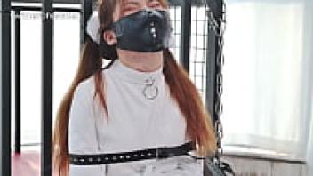 straitjacket bondage for a woman wearing an Asian latex catsuit