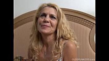 Lovely elder lady relaxes and adores her juicy pussy for you as she is lying back.