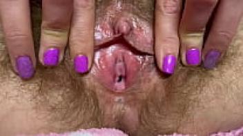 Rubbing out one orgasm in my large clit hairy pussy.