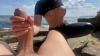 Admire a random woman wearing leather pants on a public beach.