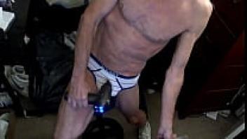 Clips from ten more minutes spent using a percussion massager while sitting on a stool wearing striped briefs